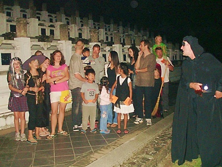 Unsuspecting guests are led through the haunted graveyard.