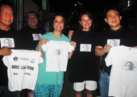 The Brotherhood gives new T-shirts to volunteer Margaret Grainger (center).