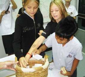 Each child writes his or her name on a piece of paper, next to the list of gifts they’d like to get.