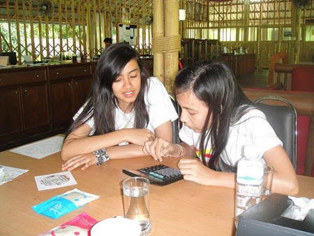 Two of the Regent’s students – Mae and Jennifer – calculate expected returns from selling the school rice.