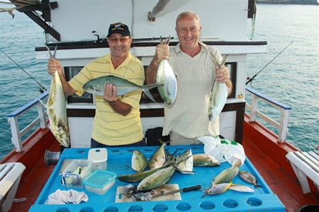 Happy fisher folk with their bountiful catch.