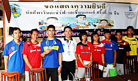 Members of the Thai windsurfing team pose for a photo with Pattaya Mayor Itthipol Khunplome, 4th left, at a welcoming home party held at Krao Surf at Jomtien Beach on November 30.