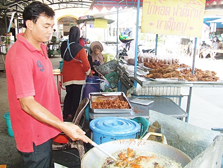 Adisak Noochan makes a living selling fried chicken. To earn extra income, he sells the used oil to a recycling merchant.