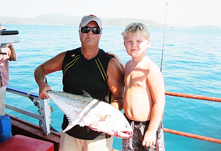 The birthday boy and his father with the queen fish.