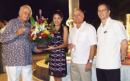 Friends bearing flowers are greeted on arrival.