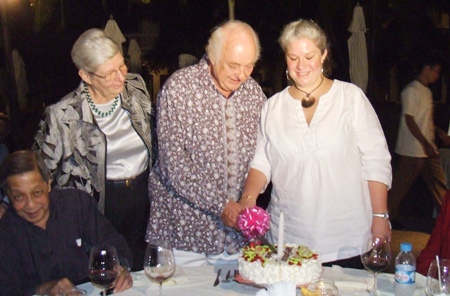 Sabine watches lovingly as Ferenc and Joyce cut the cake.