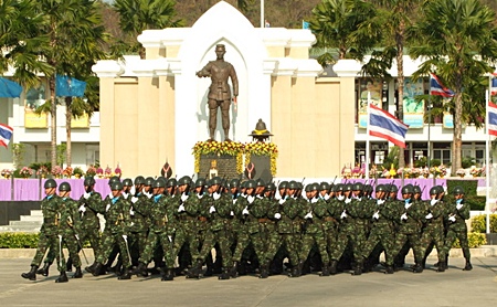 Soldiers parade past the King Naresuan monument in Chonburi.