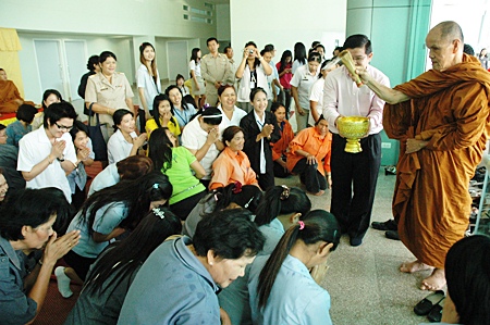 Participants at the ceremony are blessed with holy water.