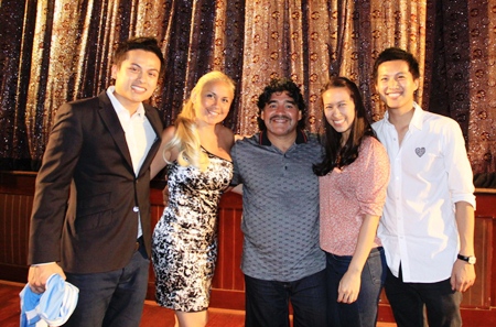 Diego Maradona, center, and his girlfriend Veronica Ojeda, 2nd left, pose for a souvenir photo with Pawin Pettrakul, Khun Thitipan and Jutipan Pettrakul during the soccer legend’s trip to the Alcazar Cabaret on Friday March 4. Maradona intimated on his visit to Pattaya that he could be interested in investing in real estate in the city.