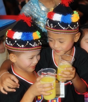 Children from the Day Care Center enjoy the free food and drink.