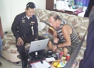 Police check Karstein Abrahamsen’s laptop computer for any incriminating evidence following his arrest at the K2M Apartments in Pattaya on Tuesday, March 1.