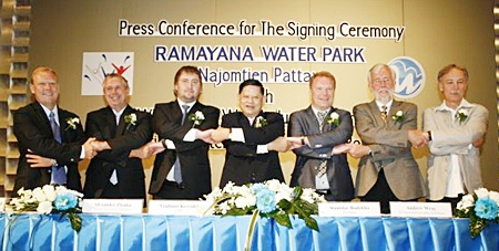 Chumpol Silapa-archa, the Minister Of Tourism & Sports, center, along with Ramayana Water Park and WhiteWater West Industries representatives shake hands at a press conference held April 8 at the Inter Continental Hotel in Bangkok to announce development plans for the water-park project. 