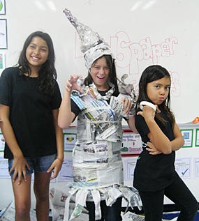 Students make “newspaper costumes” and act out!