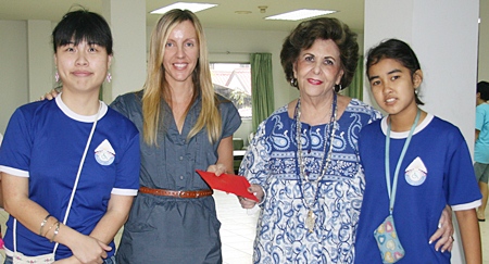 Alison Shale (second left) receives a donation from Arlette Cykman.