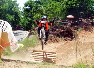 A rider flies over a ramp on the downhill course.