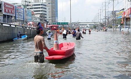 People slowly make their way towards safety in Bangkok.