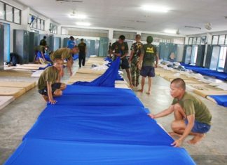 Navy cadets prepare beds for the incoming victims of devastating floods in Bangkok and beyond.