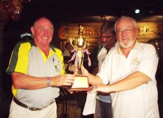 Bob Philp (left) receives the Thai Garden Resort Cup from rival captain, Helmut Wolf.