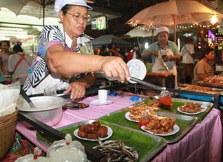 A market vendor serves up some fresh local food at Naklua’s 3rd new Walking Street project.