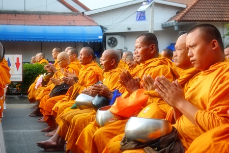 Bathed in the early morning light, monks pray for their brethren in the South.
