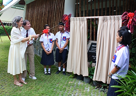 Mathew and Mary Kelly pull back the curtains to reveal the honorary plaque and officially announce the new school is open.