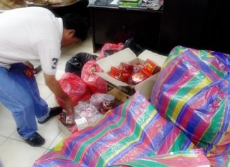 Police sort through the unlicensed, untaxed merchandise.