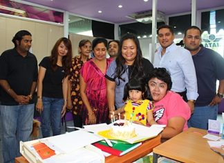 Business came to a stand still for a short spell at the Massic Travel hangar as the Malhotra family gathered around to wish Amita Malhotra (standing 3rd right) a Happy Birthday. (l-r) Vikrom, Hongsiri, Jasmeet, Malvinder, Marlowe, Prince and Ali. Foreground, Vicky is hugging the newest addition, baby Sujitra.