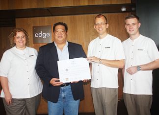 Hilton Pattaya General Manager Harald Feurstein (2nd right) presents the prize to winner Anucha Pingkarawat (2nd left) as Peta Ruiter (left), Hilton’s director of business development and Simon Bender (right), food and beverage manager look on.