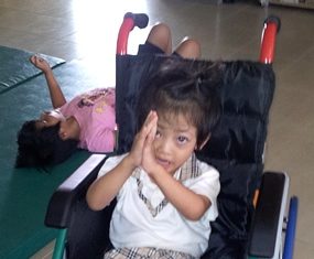 Here is Fahsai in her new wheelchair thanking all of you with a big ‘wai’.