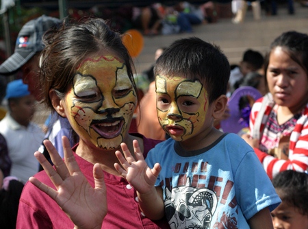 This little guy is not sure what to think about his mother’s painted face at Pattaya City Hall.