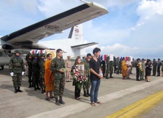 Family and comrades gather on the tarmac at Sattahip Naval Base to bring home the bodies of three marines killed by a booby-trapped bomb in Thailand’s restive south.