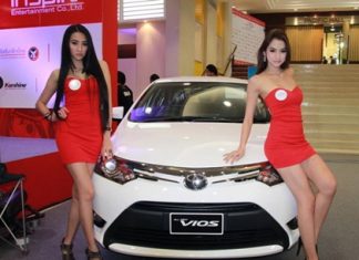 Brolly dollies drape themselves over a Toyota Vios at the Thailand Motor Festival in Sriracha.