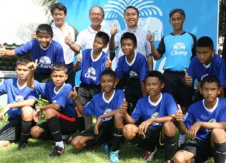 The boys from the Father Ray Children’s Home and Father Peter (second right) pose with officials from the Chang-Everton Football Academy.