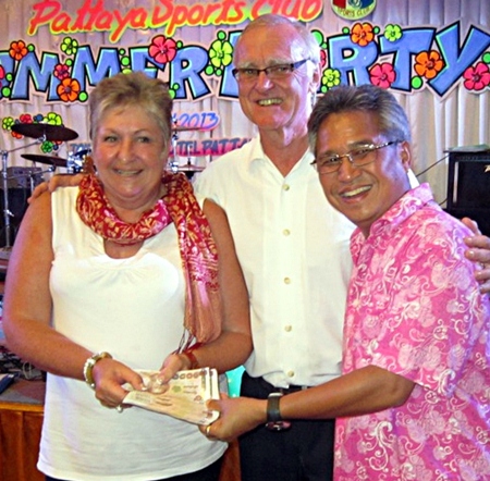 Mike (right) and Tony present a cash prize to a lucky lady.