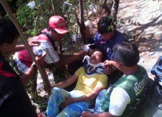Rescue workers tend to Chiew Juayee, a Chinese tourist who fell from an observation point on Pratamnak Hill.