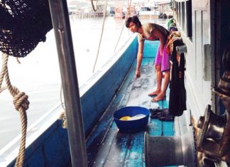 A fellow crewman points to where the deceased had been cleaning the boat when electrocuted.