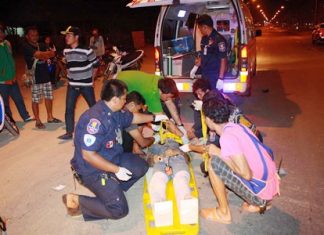 Rescue workers tend to the victim in the middle of Sukhumvit Highway.