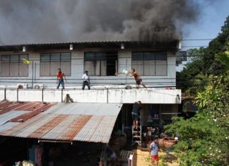 Residents attempt to extinguish the blaze whilst waiting for firefighters to arrive.