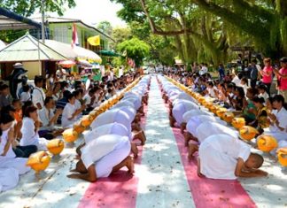 “Dhmmakaya naga” (people about to be ordained as a Buddhist monk) bow to pay respect to their families.