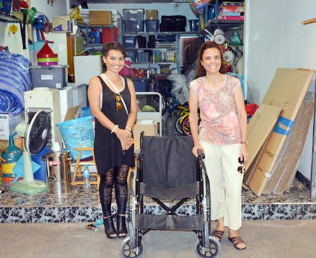 Margaret Grainger from the Hand to Hand Foundation (right) donates a surplus wheelchair to Saisamorn “Yui” Pithak (left) for her 94-year-old grandmother in Khon Kaen.