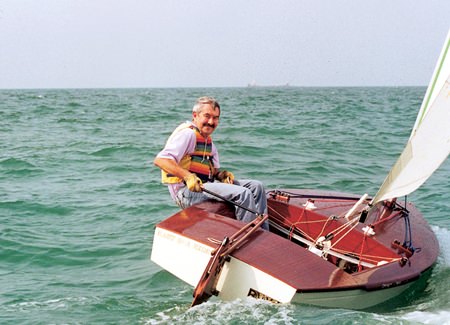 An old sea dog takes his OK dinghy for a spin around the bay.