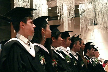 The class of 2014 listen attentively to the speeches in the Hilton Ballroom.