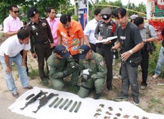 Officials inspect a cache of weapons found in Sattahip.