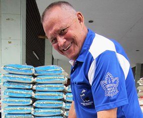 Bill hands out rice to families with disabled children in Nongprue.