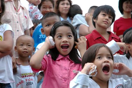 Children watch the stage entertainment at last year’s event.