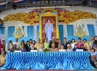 Organizing officials gather for a group photo during the announcement of free vocational classes for Muslim residents.