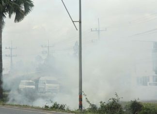 The crew burns cut grass and vegetation in a roadside ditch, causing poor visibility and creating some near misses.