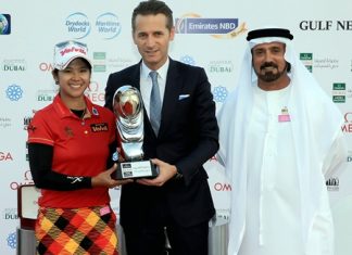 Thailand’s Pornanong Phatlum (left) is shown receiving the 2013 winner’s trophy from Raynald Aeschlimann, vice president, International Sales Director of Omega, as Mohamed Juma Buamaim, vice chairman and CEO of golf in DUBAi, looks on.