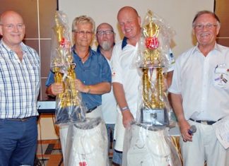 Tournament winners Tore Eliassen and Odd Holm-Hansen receive their prizes from Graham MacDonald MBE (left), President of the Royal British Legion, Emcee Derek Brook (right) and Max Matthews (standing rear centre)