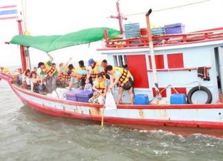 Employees from local hotels set overboard artificial plants made from rope to help restore the marine ecosystem off the shores of Naklua.